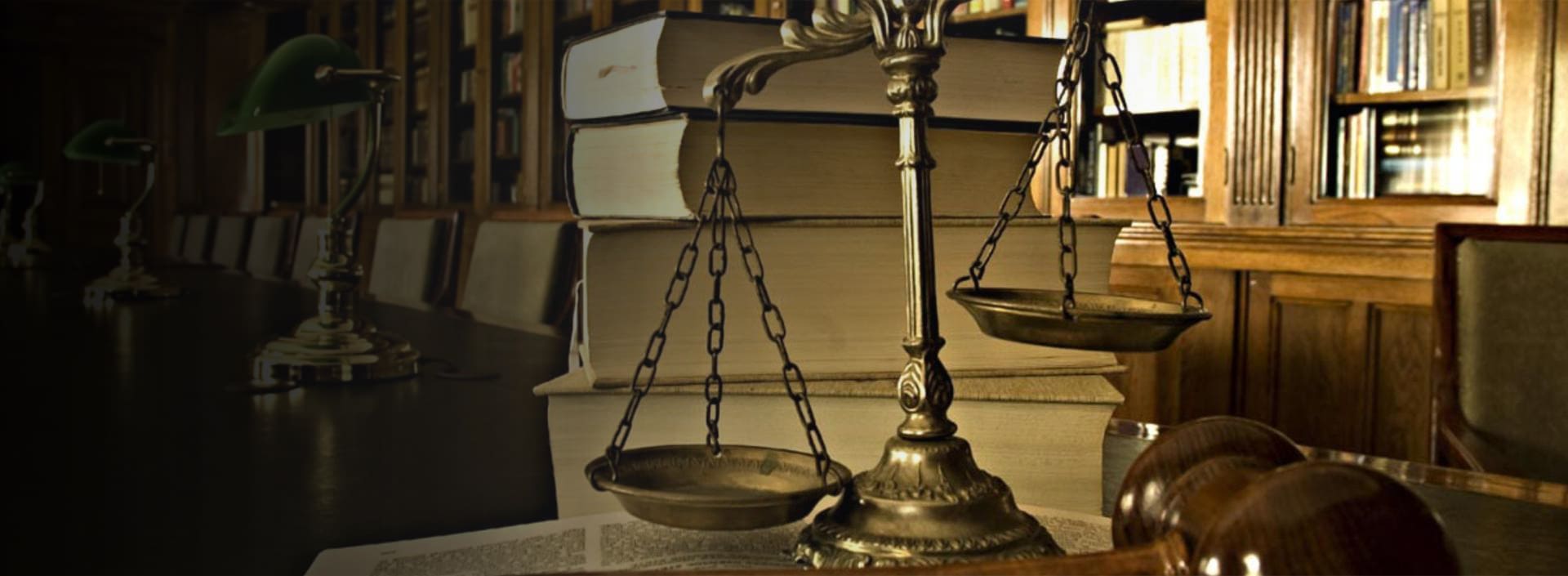 A close up of the scales of justice on top of books.